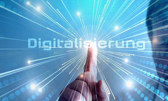 Der Zeigefinger eines Mannes zeigt auf das Wort "Digitalisierung".